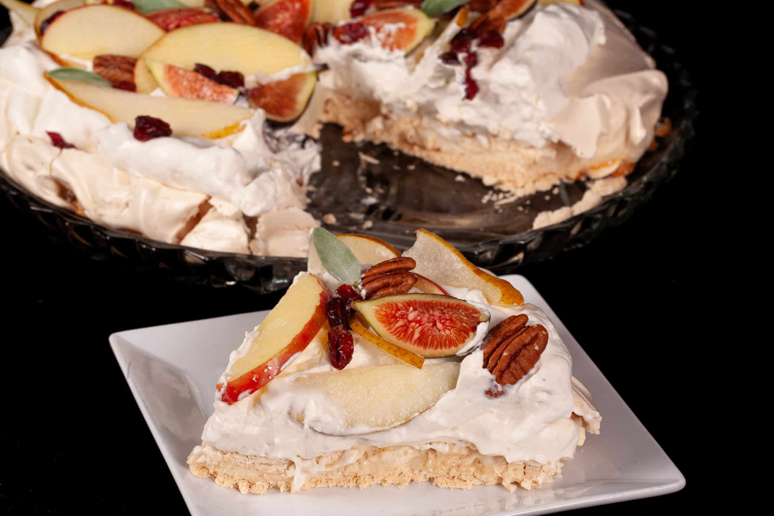A Thanksgiving pavlova with maple meringue base, maple syrup whipped cream, apples, pears, figs, pecans, dried cranberries, and sage leaves.
