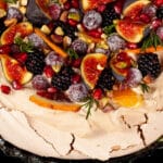 A Christmas pavlova with a gingerbread meringue base, gingerbread flavoured whipped cream, figs, oranges, sugared cranberries, blackberries, pomegranate arils, pistachios, and rosemary.