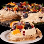 A gingerbread pavlova with a gingerbread meringue base, gingerbread flavoured whipped cream, figs, oranges, sugared cranberries, blackberries, pomegranate arils, pistachios, and rosemary.